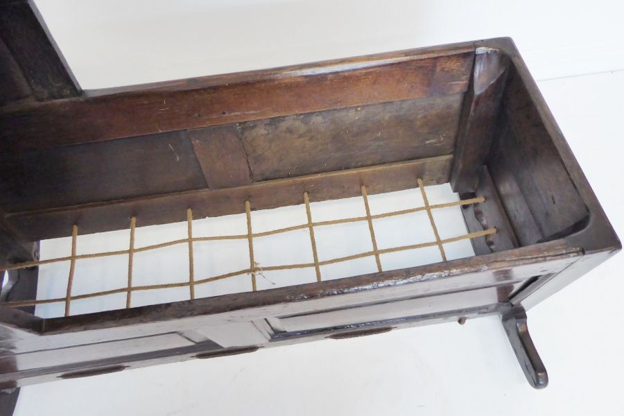 An 18th century oak child's cot; the hood above various fielded panels (replaced rockers) (97cm - Image 6 of 10