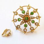 An Edwardian green garnet, half pearl and yellow gold pendant/brooch of openwork circular design