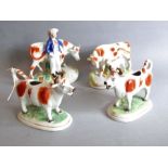A pair of 19th century Staffordshire cow creamers together with two other similar figures (4)