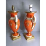 A pair of 19th century Paris-style porcelain vases in the form of two-handled urns; the handles with