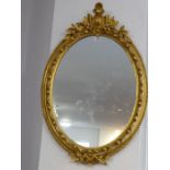 A pair of 19th century (with new backs) oval gilt framed wall hanging looking glasses; each