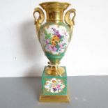 A mid-19th century Paris-style vase of urn form; hand-gilded and decorated with floral sprays, two