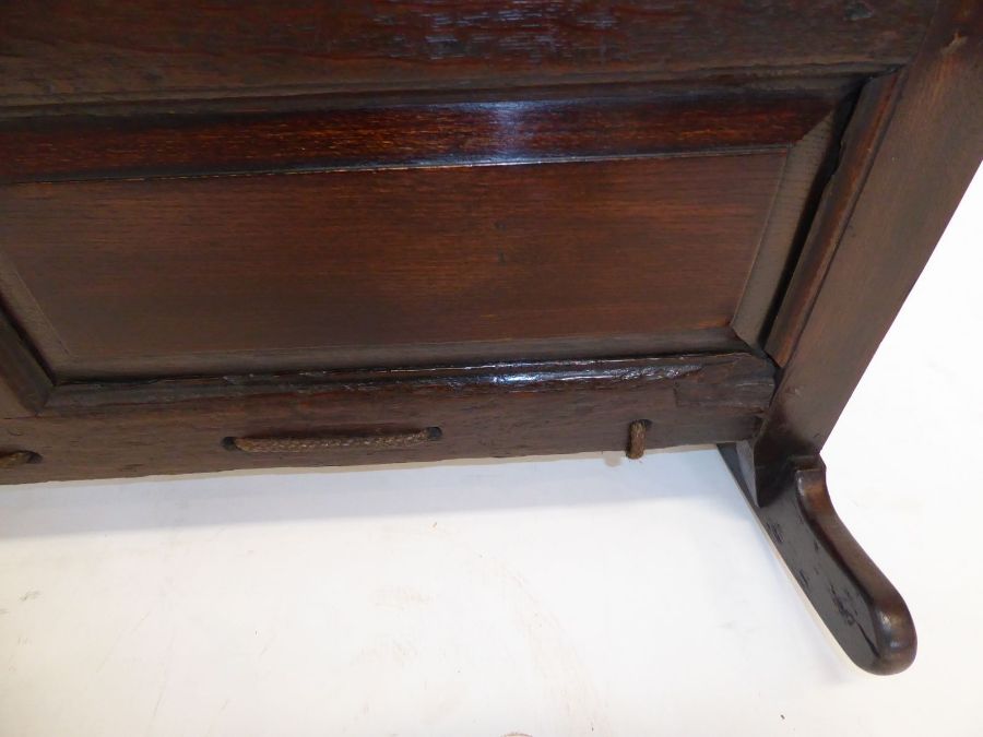 An 18th century oak child's cot; the hood above various fielded panels (replaced rockers) (97cm - Image 10 of 10