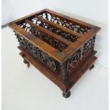 A mid-19th century three-division figured walnut Canterbury of large proportions; ornately pierced