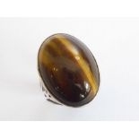 A large, heavy and striking 1970s dress ring; custom-made with centrally set vertical cabochon