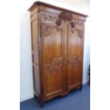 A fine early 19th century French pitch pine armoire of good colour and large proportions: the outset