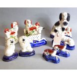 A selection of 19th century hand-decorated Staffordshire dogs to include a pair of King Charles