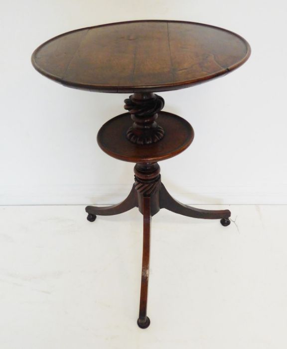 A late 18th / early 19th century circular oak-topped drinking-table; the slightly dished top above a