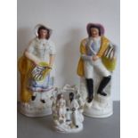 A pair of large 19th century hand-decorated Staffordshire Pottery figures 'The fish sellers',