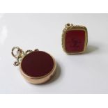 An early 19th century gold cased seal, ornately carved containing a carnelian intaglio-engraved with