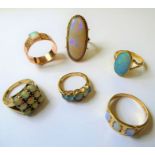 Six opal-set rings including an oval opal hallmarked 18-carat yellow gold collet and bifurcated