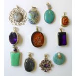 A good and interesting selection of eleven various silver pendants; some set with semi-precious