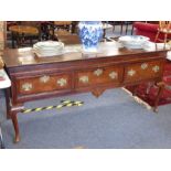 A large mid-18th century oak dresser base; the overhanging moulded top above three drawers
