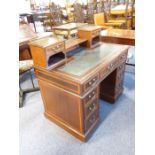 A good Edwardian period mahogany and satinwood pedestal writing desk; the superstructure with gilt-