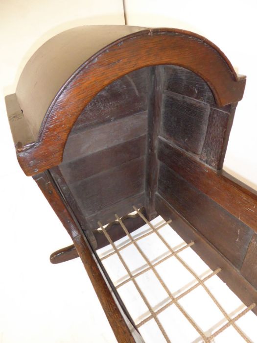 An 18th century oak child's cot; the hood above various fielded panels (replaced rockers) (97cm - Image 5 of 10