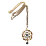 A boxed Edwardian 9-carat yellow gold openwork lobed pendant with foliate decoration mounted with