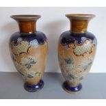 A matched pair of late 19th century Royal Doulton stoneware vases. Flowering necks above baluster-