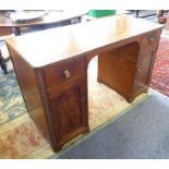 An early 19th century Regency period mahogany desk; the ebony-strung reeded edge top above two