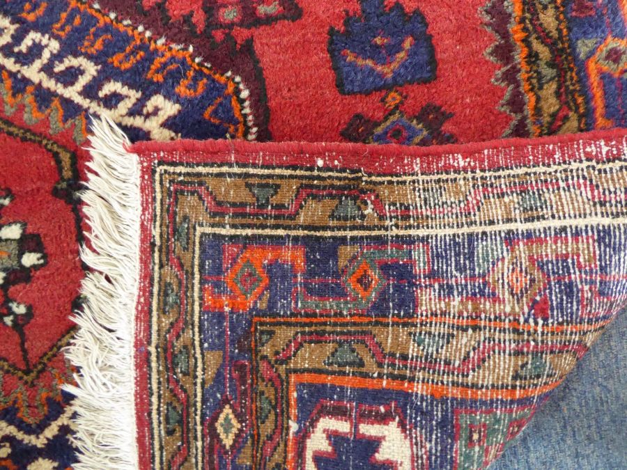 A red ground Hamadan hand knotted rug with three rug with three central lozenges against a red - Image 5 of 5