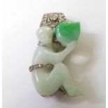 An Art Deco, jadeite and diamond-set single clip brooch; the carved jadeite seated monkey holding