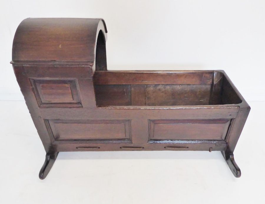 An 18th century oak child's cot; the hood above various fielded panels (replaced rockers) (97cm - Image 9 of 10