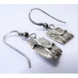 A pair of silver ear pendants, each rectangular plaque depicting a stylised animal in relief,