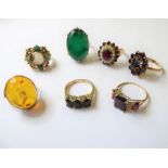 Seven assorted gem-set rings: three garnet set and yellow gold rings, a 9-carat yellow gold