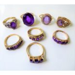 Eight amethyst set and 9-carat yellow gold rings, three with diamond-set detail and one with a