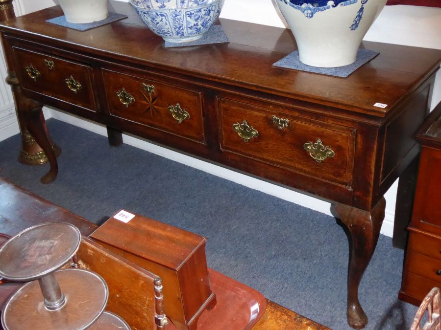 A good mid 18th century oak dresser base; the moulded top above three frieze drawers, the central