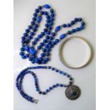 Three items of lapis lazuli jewellery: a spherical bead necklace with occasional tumbled nuggets and