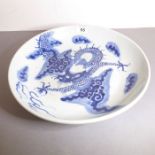 A Chinese porcelain bowl, probably 18th century. Decorated in underglaze blue with a four-clawed