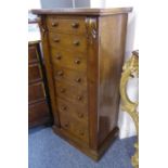 A 19th century mahogany Wellington chest; the two verticals carved at the top with volutes and the