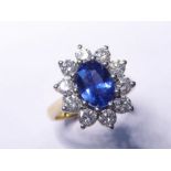 A cornflower sapphire and diamond cluster ring (matching lot 339)