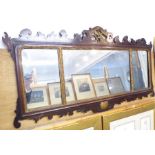 An 18th century style (later) mahogany and parcel-gilt-framed looking glass; centrally decorated