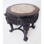 A 19th century Chinese carved hardwood and marble-topped jardinière stand; the gadrooned top with