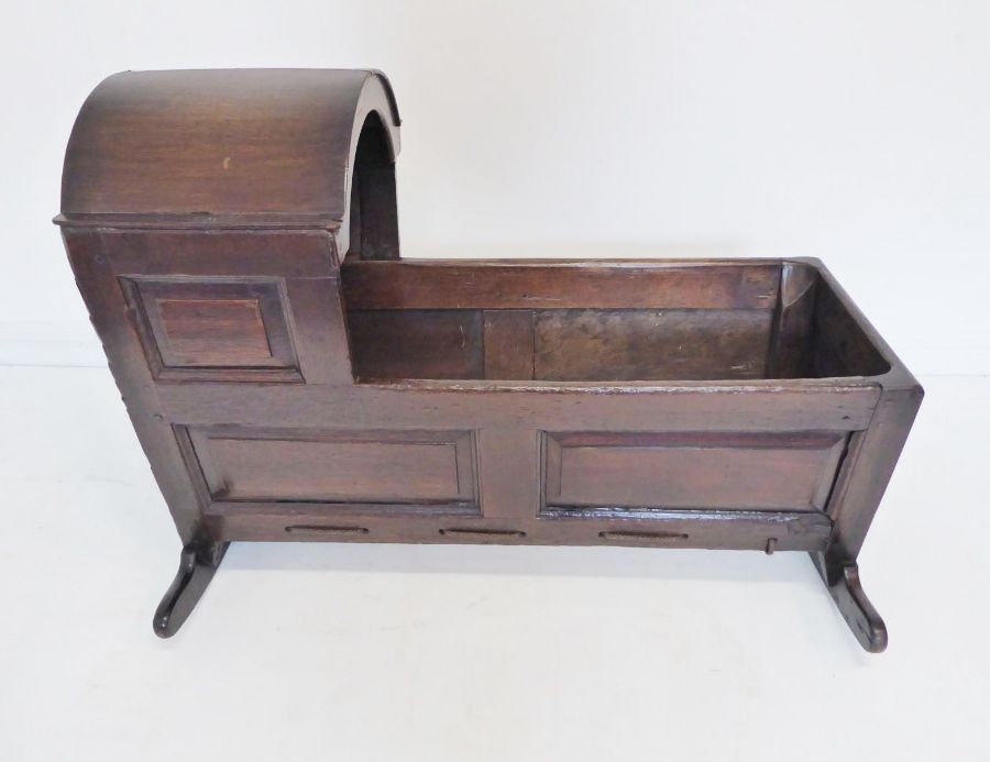 An 18th century oak child's cot; the hood above various fielded panels (replaced rockers) (97cm - Image 3 of 10