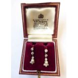 A pair of pearl and diamond-set ear pendants each with a pearl (untested) terminal suspended from an