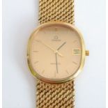 An Omega gentleman's wristwatch; the 9-carat gold-cased movement having a champagne-coloured dial,