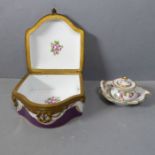 An early 20th century leaf-shaped Dresden porcelain inkwell and cover, hand gilded and decorated