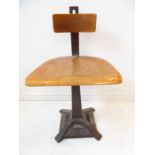 An early 20th century Singer sewing-machine chair. Revolving, bentwood-style saddle seat and heavy