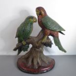 A heavy cast-iron doorstop modelled as two parrots perched upon a branch, probably mid-20th century