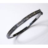 A silver bangle set with hand-cut cubic zirconia-style stones (boxed)
