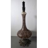 A highly ornate bottle vase-shaped table lamp; the elongated tubelined-style neck above squat