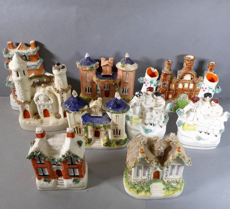 A good selection of 19th century Staffordshire spill vases and models of castles etc. in pastille