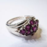 A silver dress ring set with nine hand-cut rose-coloured stones in a lozenge design, ring size P (