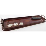 An elongated mahogany two-handled serving tray decorated centrally with a marquetry conch shell.