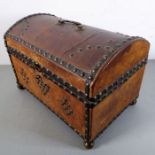 A small dome-topped, leather-covered and studded chest. The lid with gilded (now rubbed) swan-neck