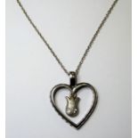 A heart-shaped silver pendant with central dropper set with small white stones, suspended upon a