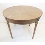 A circular gold-painted centre table on turned, tapering fluted legs headed with painted