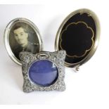 Three silver picture frames: an oval sterling silver easel picture frame; a silver easel picture
